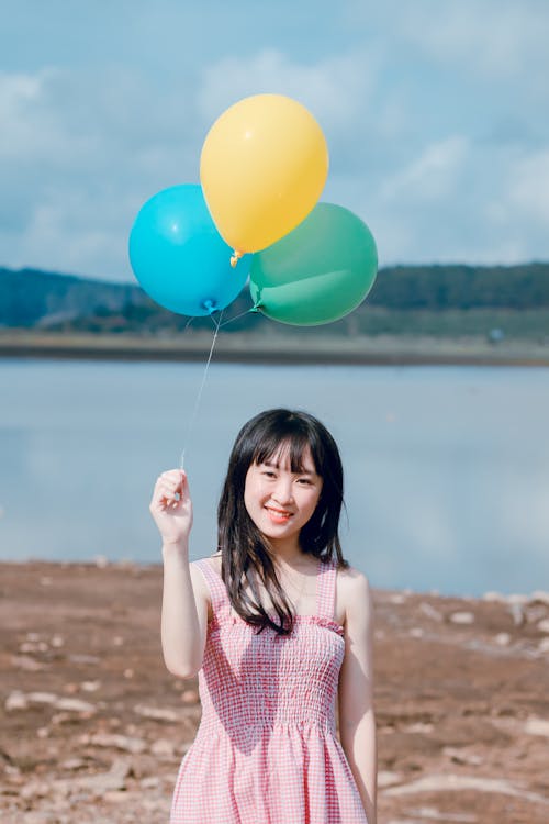 Free Photo of Woman Holding Balloons Stock Photo