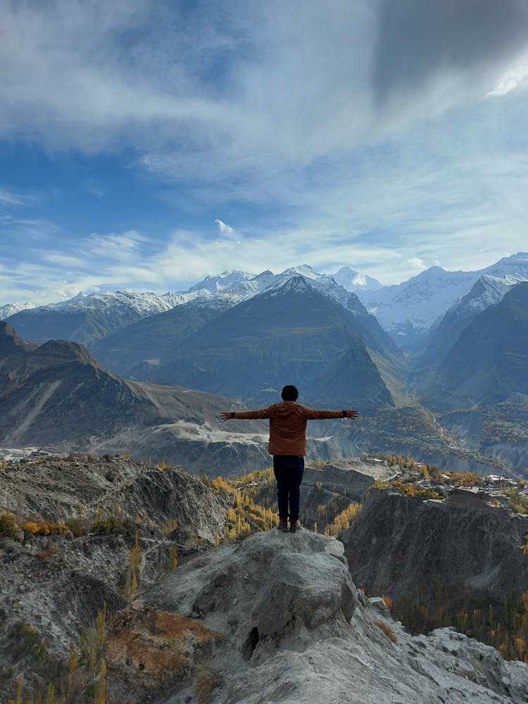 Person Standing On Mountain Top