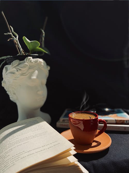 açık kitap, bir fincan kahve, dikey atış içeren Ücretsiz stok fotoğraf