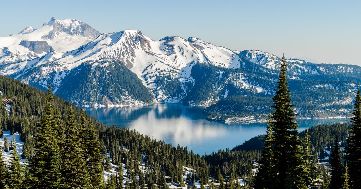 Beautiful landscape of snow-capped mountains and a pristine lake in British Columbia, Canada.