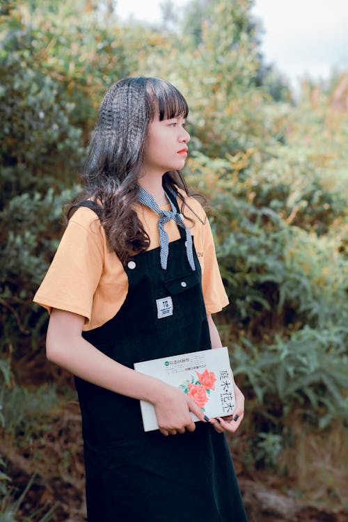 Woman In Black Dungaree And Orange Shirt