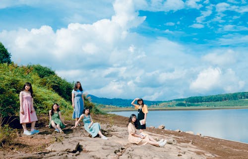 Women Sitting Near Body Of Water