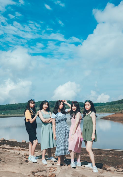 Women Standing Near Body Of Water