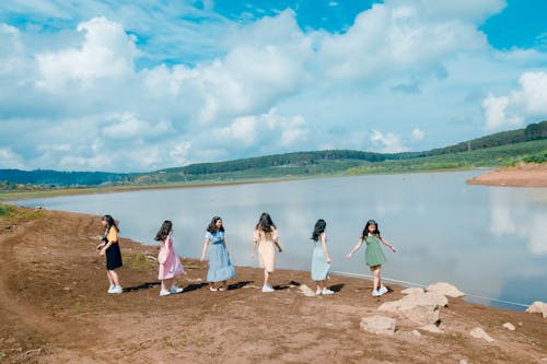 Six Girl Standing Beside Body of Water