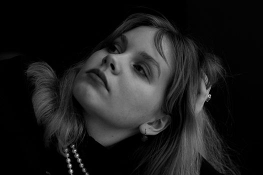 Close-up monochrome headshot of a woman in thoughtful pose.