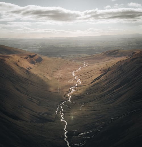 View of River Meandering in Wide and Uninhabited Valley