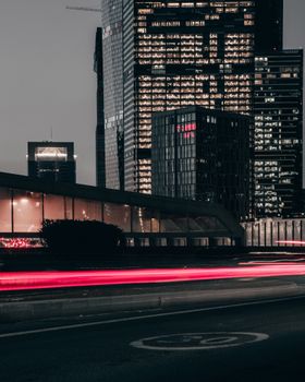Evening cityscape of Moscow with skyscrapers and light trails creating a dynamic urban scene.