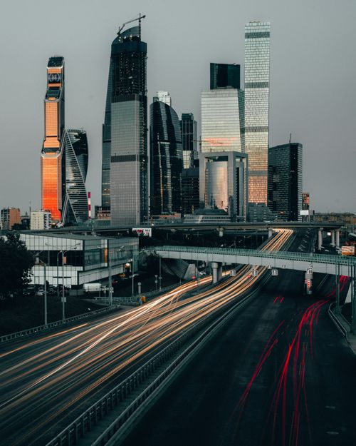 Free A stunning view of Moscow's skyline with skyscrapers and light trails at twilight, showcasing urban beauty. Stock Photo