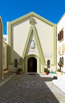 Charming facade of a historic church in Rhodes, Greece, with unique architectural style.