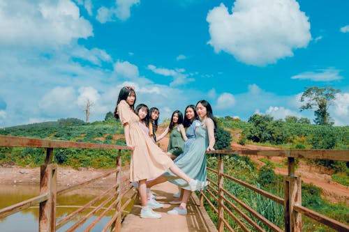 Free Group of Women Standing on Brown Bridge Stock Photo