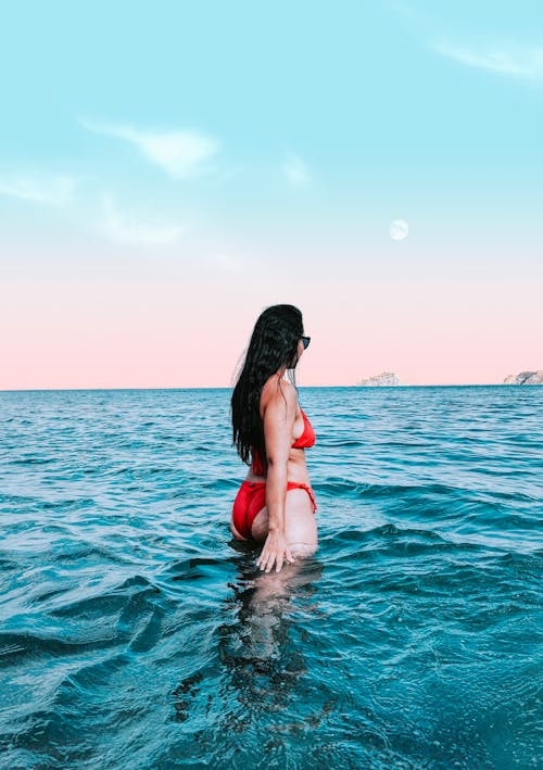 Woman in Red Bikini Standing on the Beach