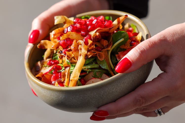 Person Holding A Bowl Of Salad