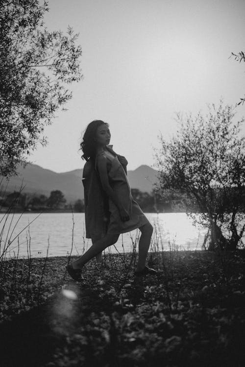 Woman in Coat Posing on Lakeside