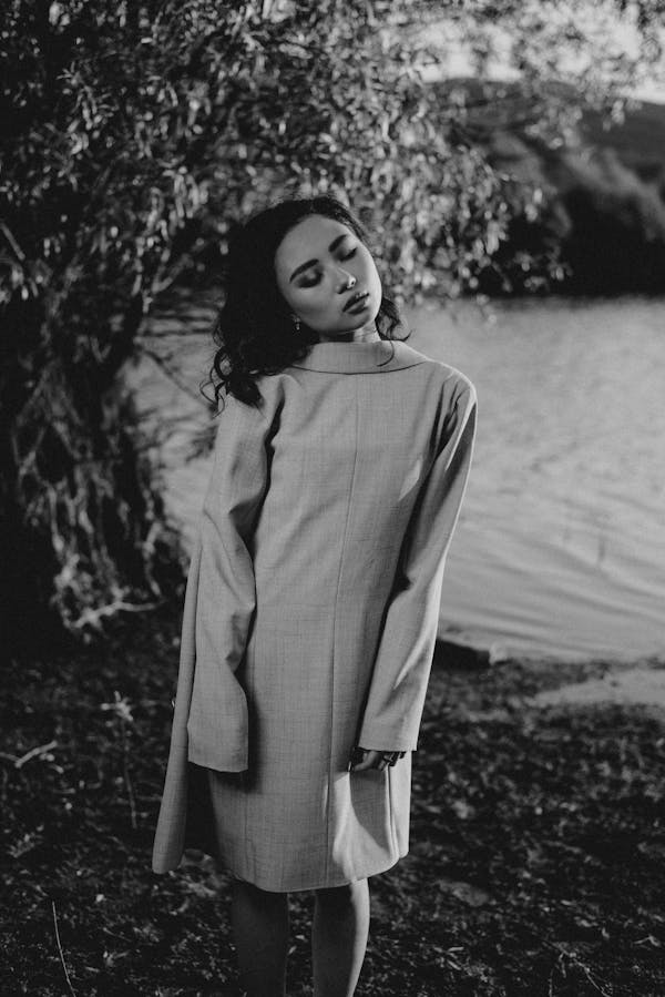 Grayscale Photo of Woman in Long Sleeve Dress