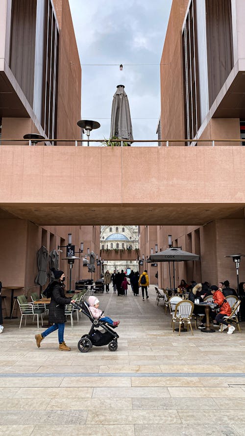 People Walking and Sitting in an Alley