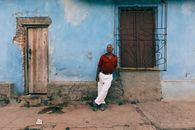 Man Red Polo Shirt Standing Beside a Window