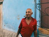 Man in Red Polo Shirt Smoking Cigarette