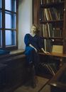 Woman in Blue Robe Sitting on Chair