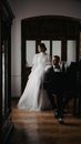 Bride and Groom Standing Beside Piano