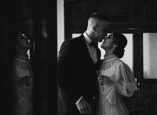 Free Elegant couple sharing a romantic moment in black and white indoors. Stock Photo
