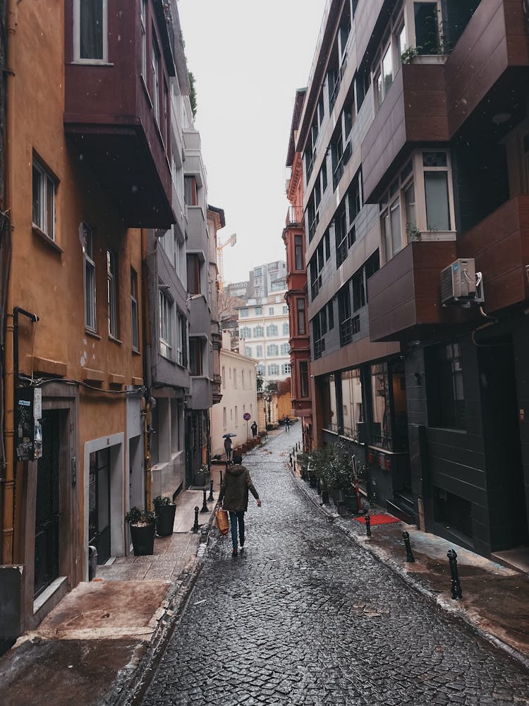 Woman Walking On Empty Street In Town