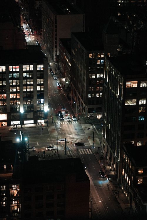 Free Aerial view of Toronto's city streets at night, showcasing urban architecture and illuminated buildings. Stock Photo