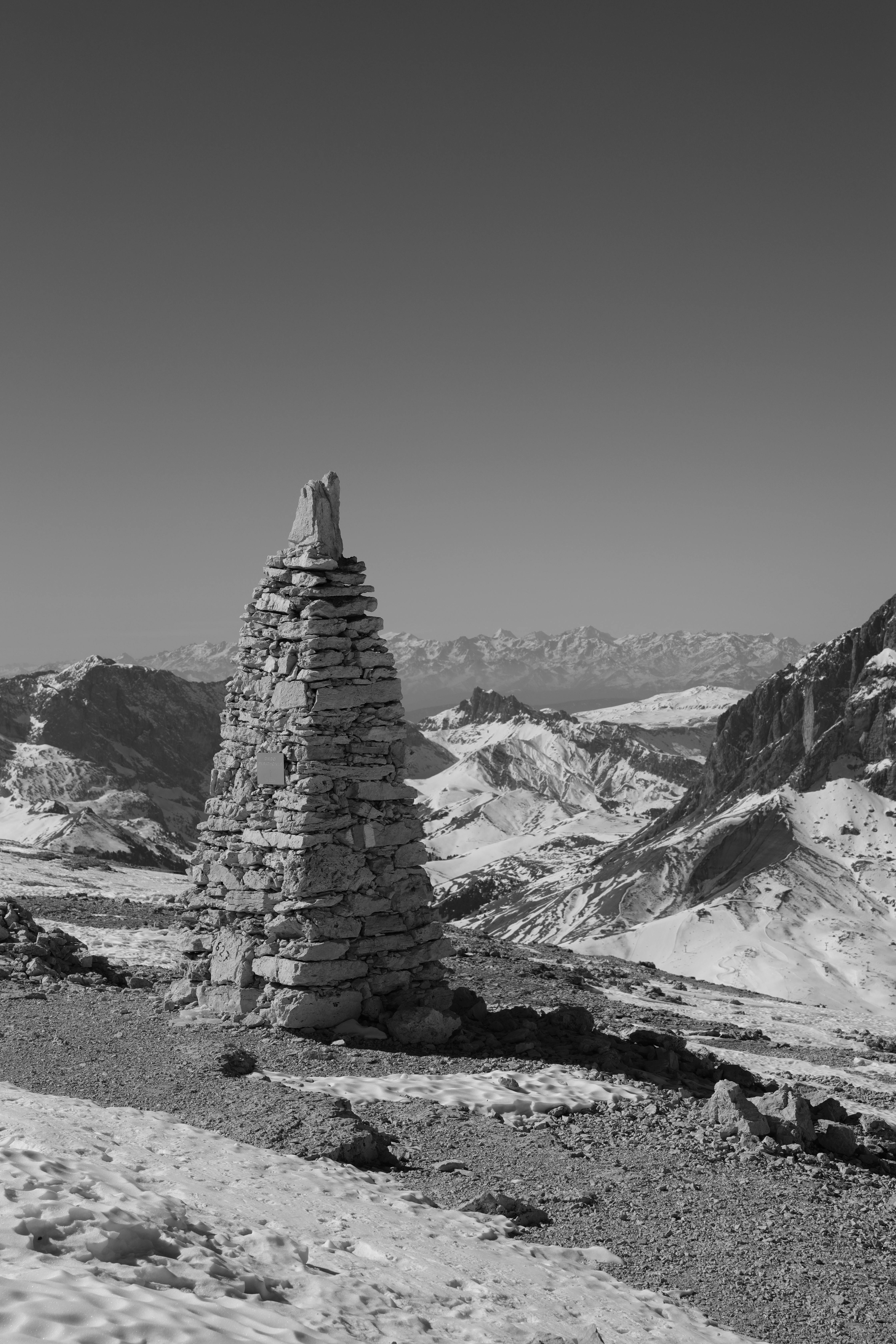 Prescription Goggle Inserts - Captivating black and white mountain landscape featuring a stone cairn in a snowy desert.