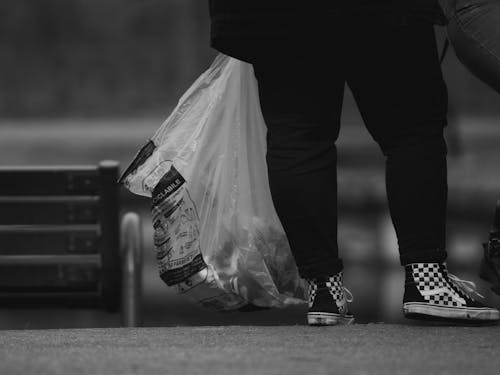 Woman Legs and Plastic Bag on City Street