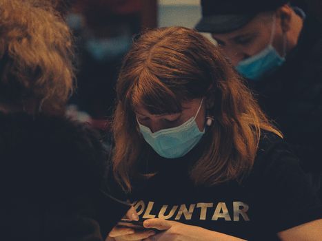 Woman in Black and White Crew Neck Shirt Wearing White Mask