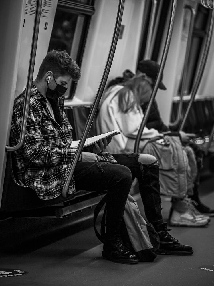 Grayscale Photo Of People In The Train