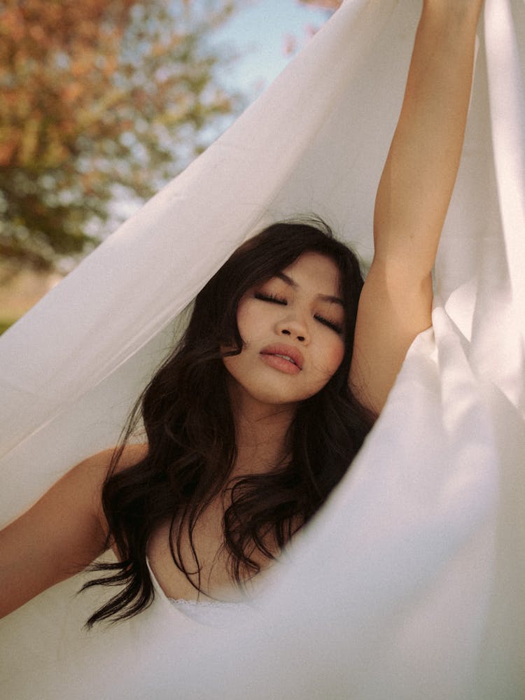 Young Woman With Black Long Hair Wrapped In White Fabric 