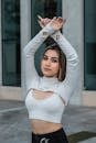 A Woman in White Long Sleeves Raising Her Hands