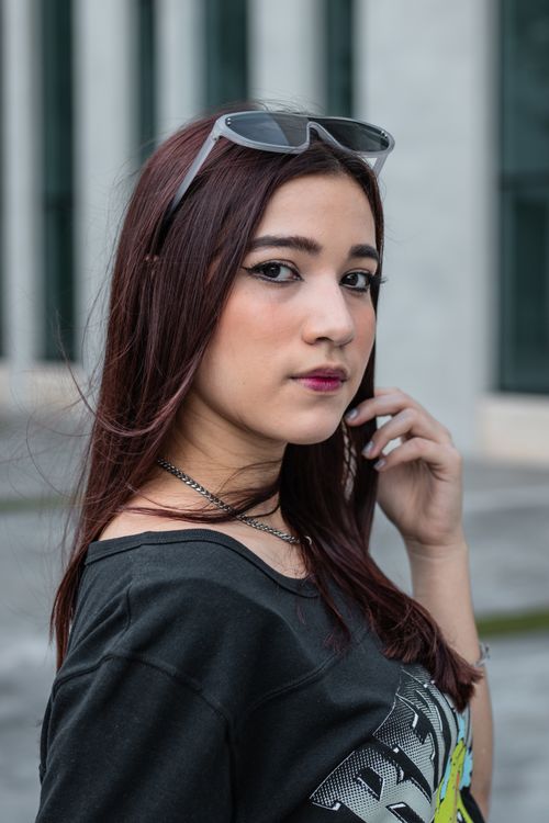 Free Stylish young woman with sunglasses on head in urban setting. Perfect lifestyle portrait. Stock Photo