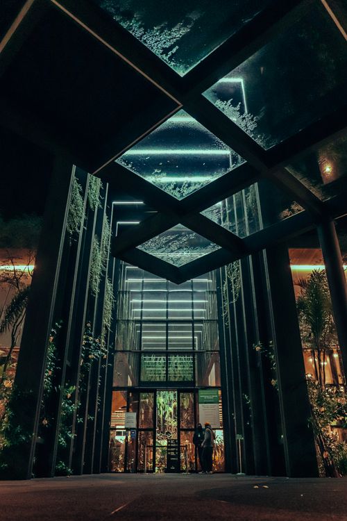 Free Dramatic view of a modern skyscraper entrance illuminated at night in São Paulo, Brazil. Stock Photo