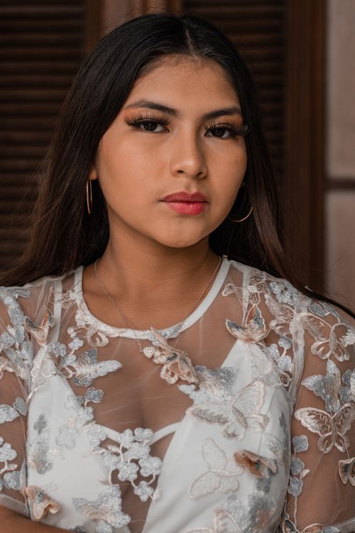 Free Portrait of a young woman in elegant bridal attire with delicate floral embroidery. Stock Photo