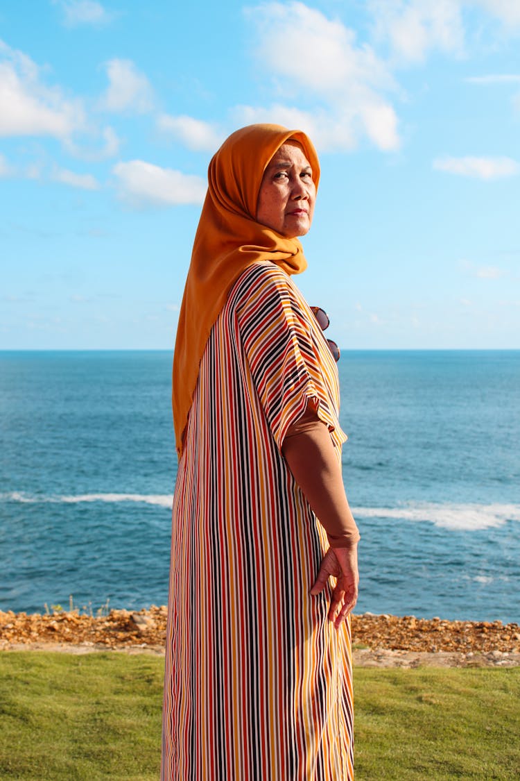 Elderly Woman In Headscarf Standing Near Sea