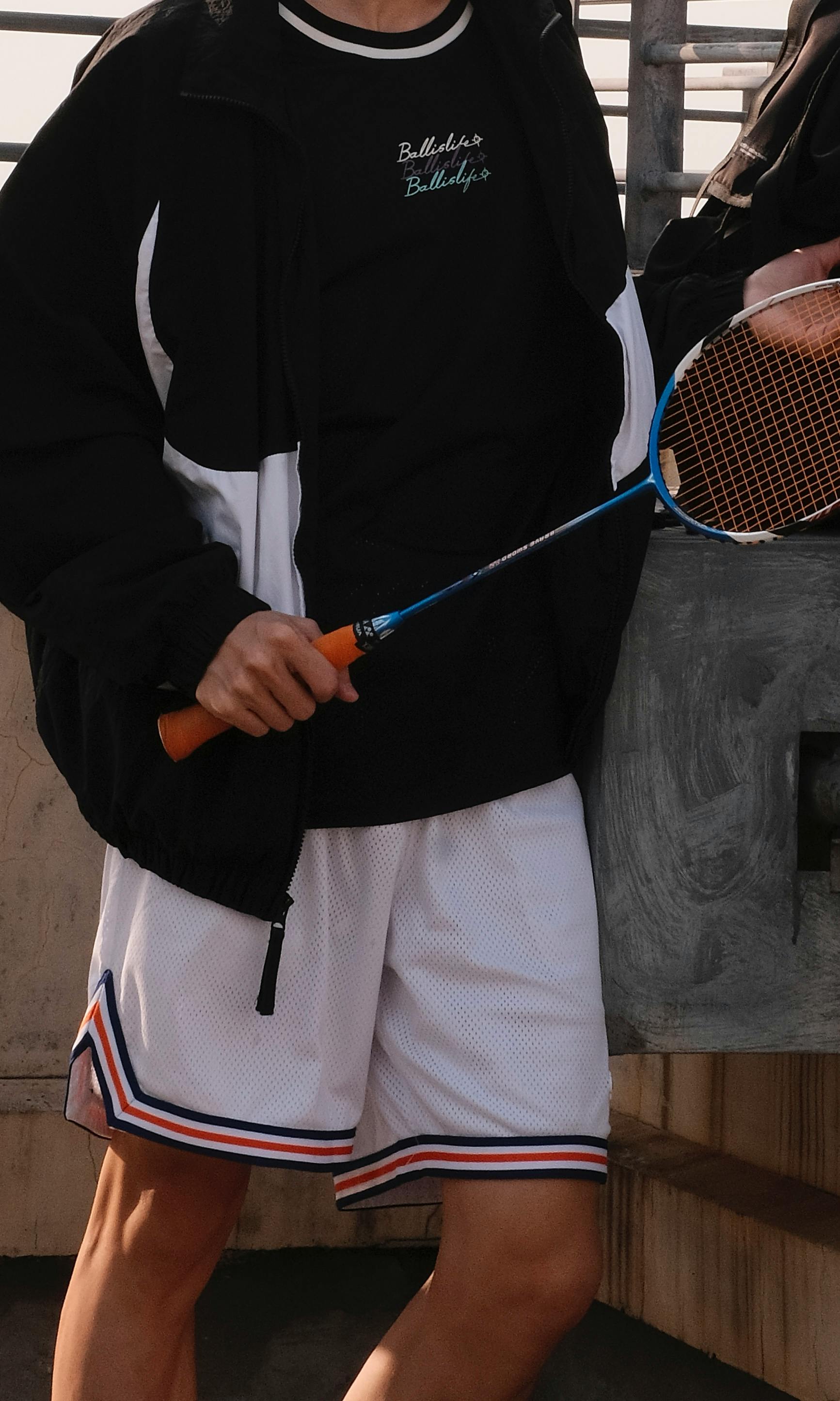 a person holding a badminton rocket