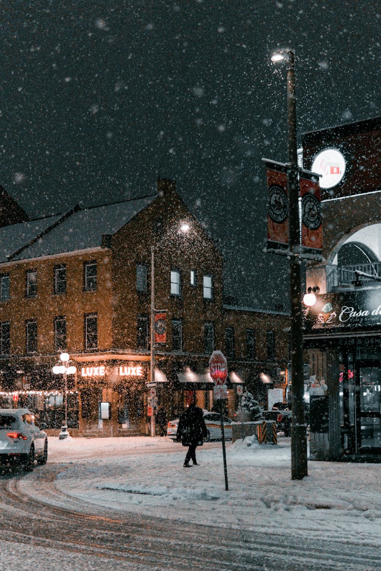 Person Walking On Snow Covered Sidewalk