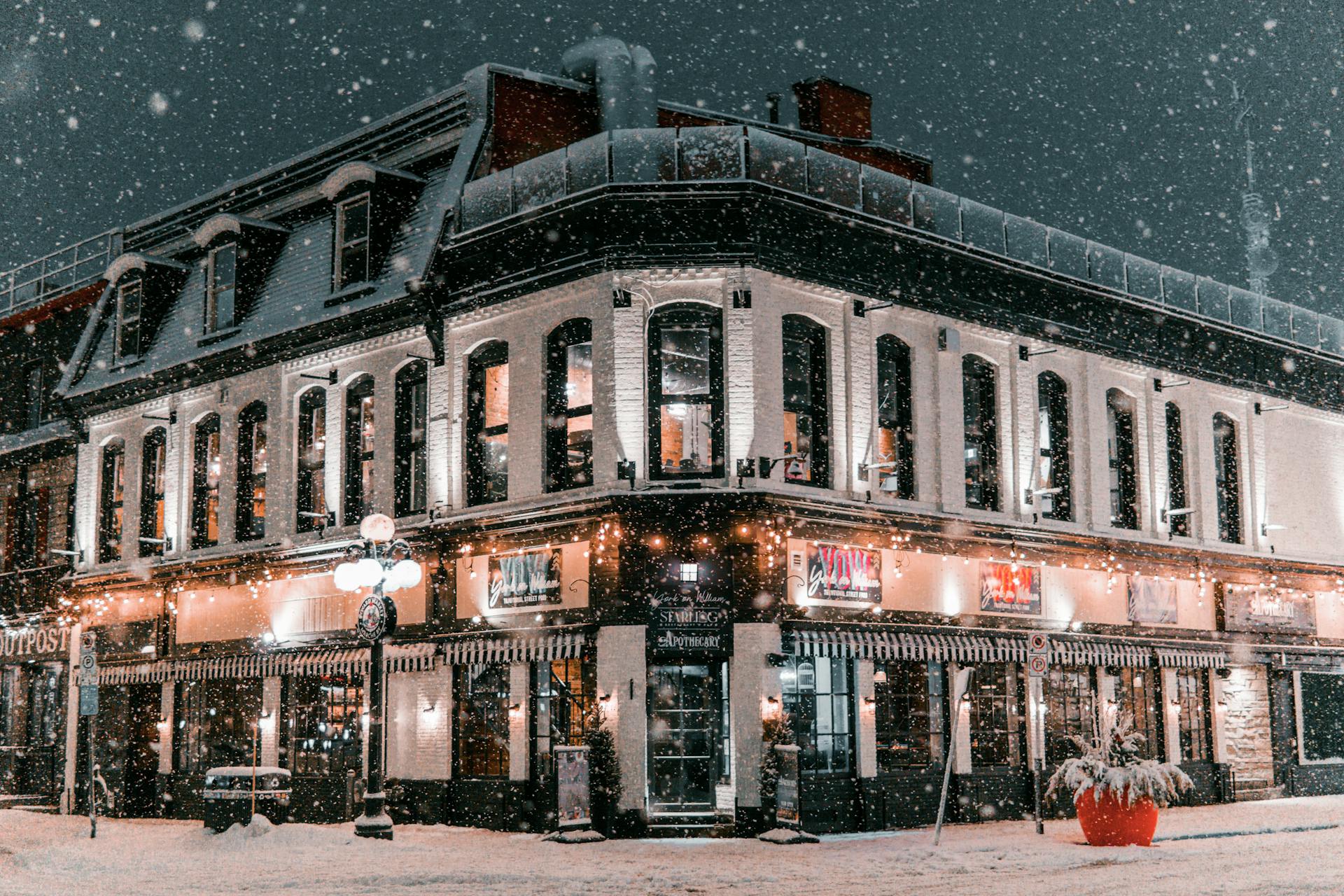 Enchanting night snow scene in Ottawa with a beautifully illuminated historical building.