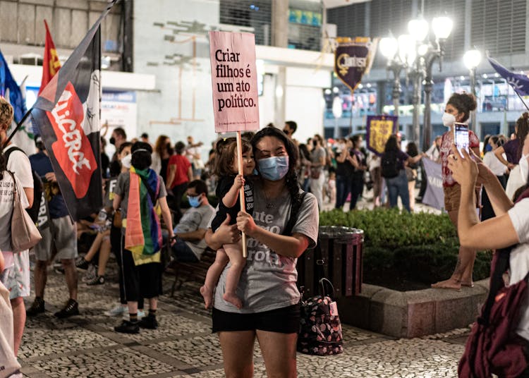 Woman Protesting With Baby In Arms