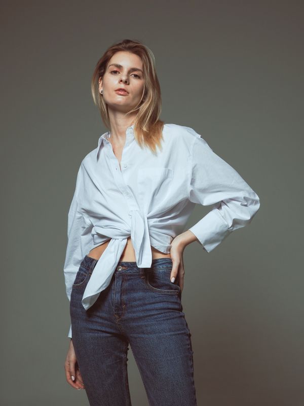 Woman wearing dark jeans and a nice blouse at a casual party