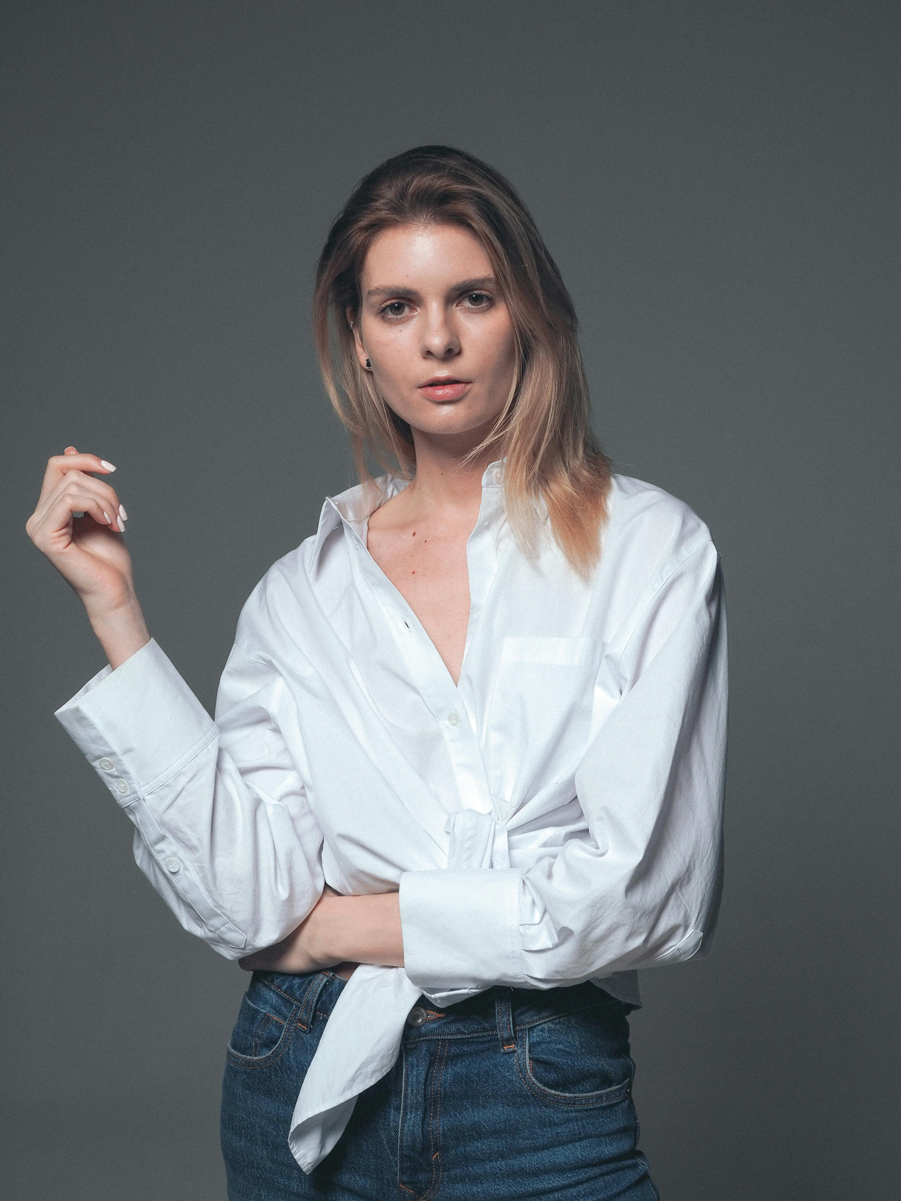 Woman in White Long Sleeve Shirt and Denim Jeans · Free Stock Photo