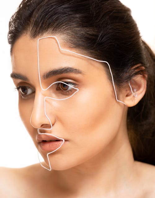 Free Portrait of Woman with White Wire Going Across Face Stock Photo