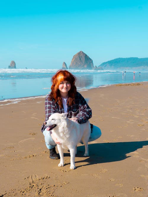 Free A Woman With Her Dog at the Beach Stock Photo
