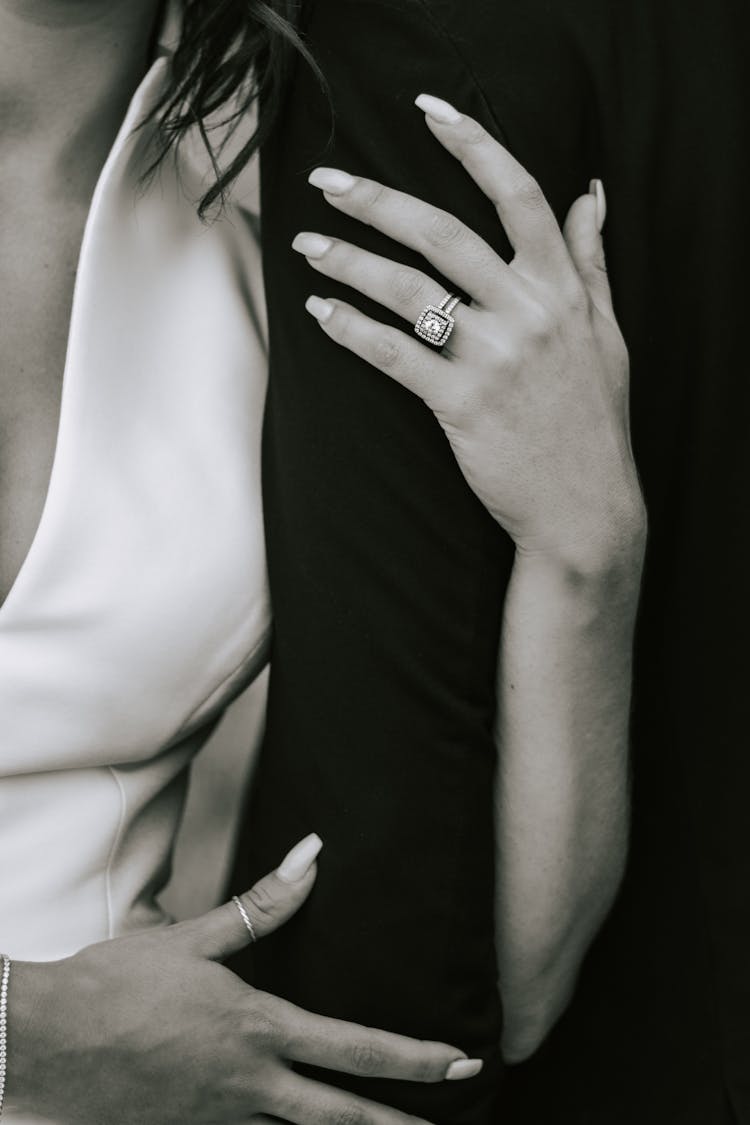 Black And White Close Up Of Womans Hands Around Mans Arm