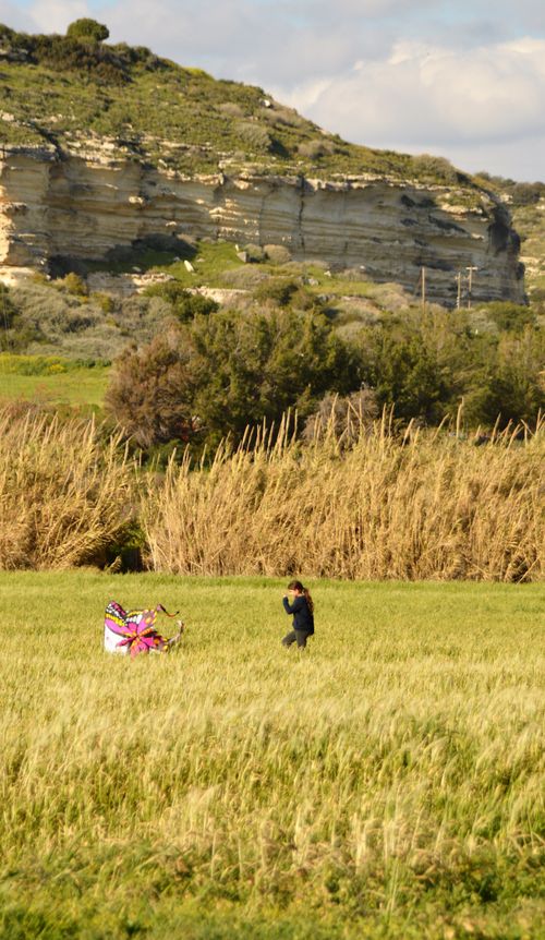 Free girl with kits on ground in field Stock Photo