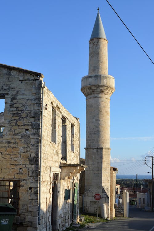 Old disused Mosque with Stop sign and derelict building