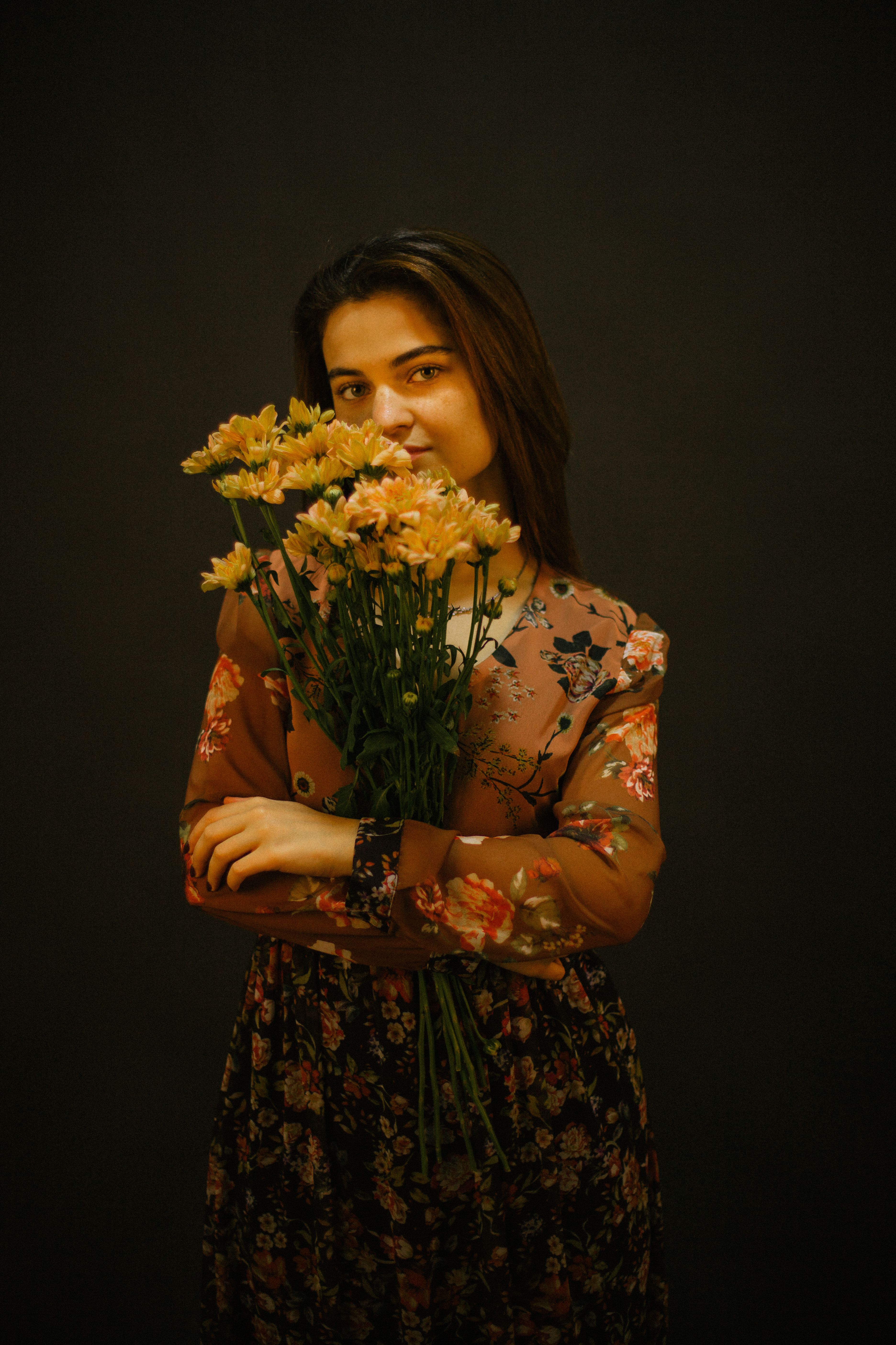 Beautiful Woman in a Floral Dress Holding a Bouquet of Flowers · Free ...
