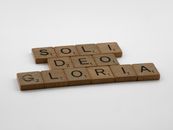 Brown Wooden Scrabble Tiles on a White Surface