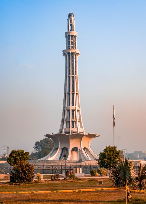 Free The iconic Minar-e-Pakistan tower in Lahore standing tall against a blue evening sky. Stock Photo